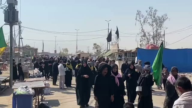 Foreign pilgrims walk along a road in Iraq during the Arbaeen pilgrimage as security measures remain in place.